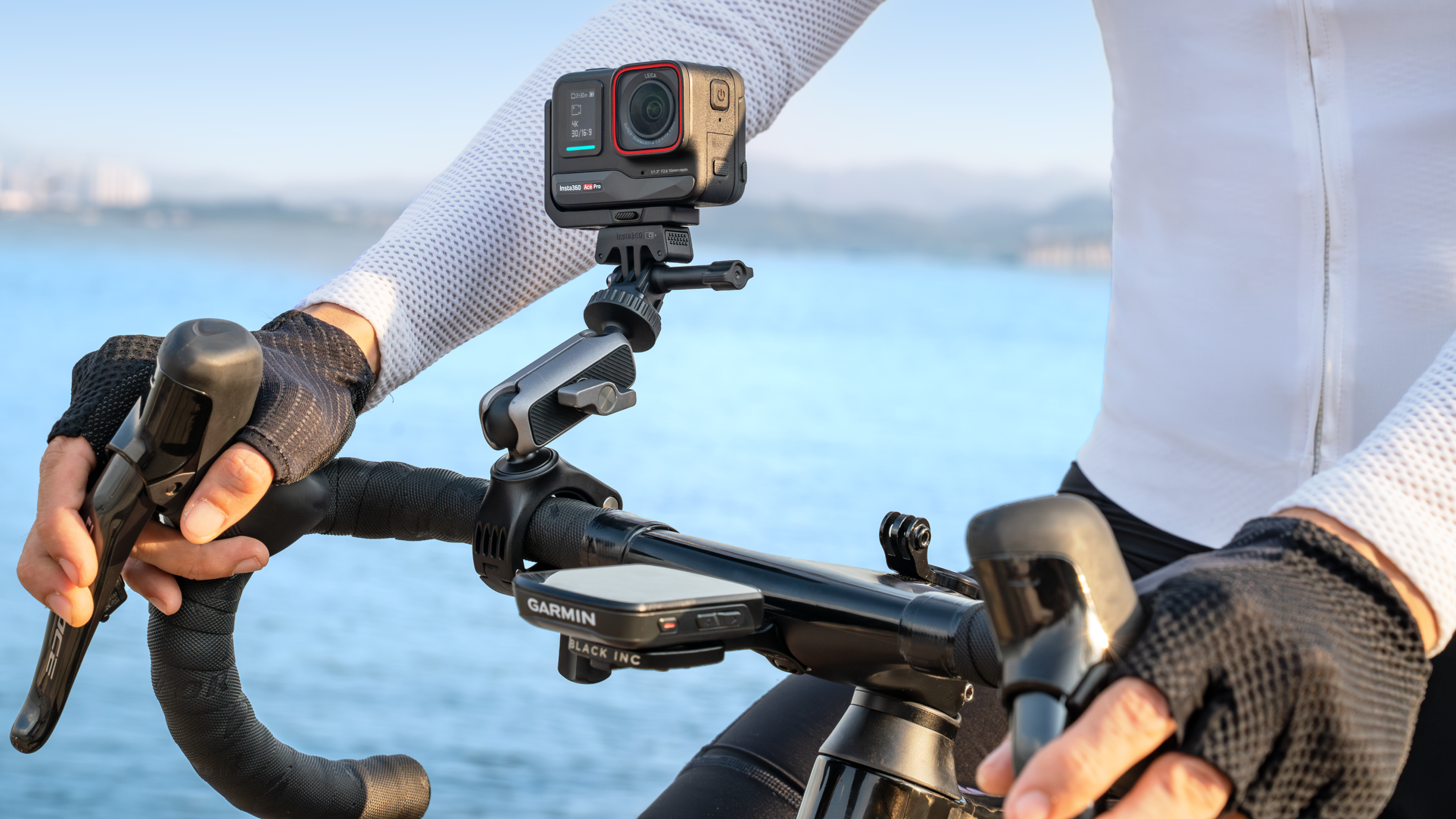 A cyclist mounting Ace Pro on their handlebars with Garmin remote pictured.